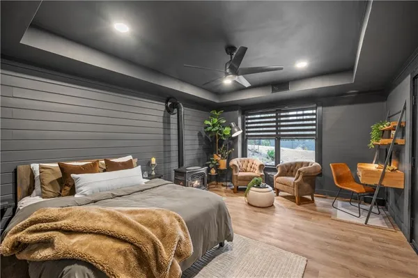 a bedroom with furniture and a large window