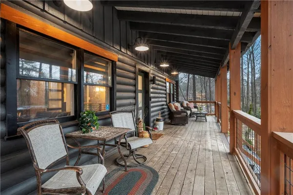 a view of a patio with table and chairs and wooden floor
