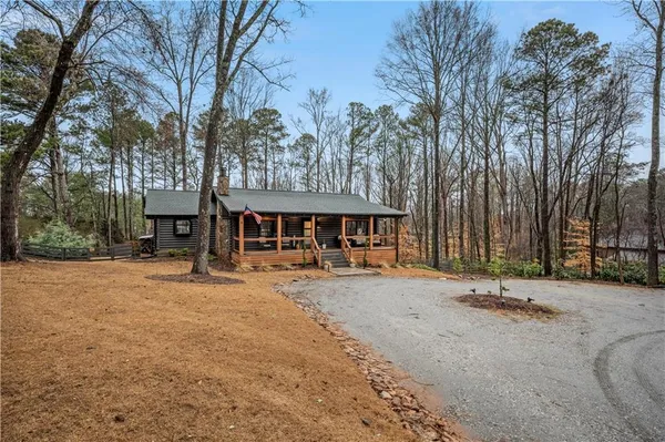 a backyard of a house with barbeque oven and outdoor seating