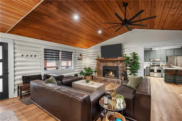 a living room with furniture a fireplace and a flat screen tv