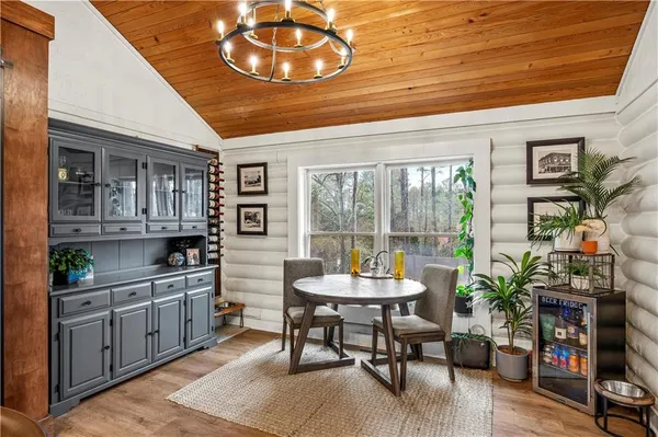 a view of a dining room with furniture window and wooden floor