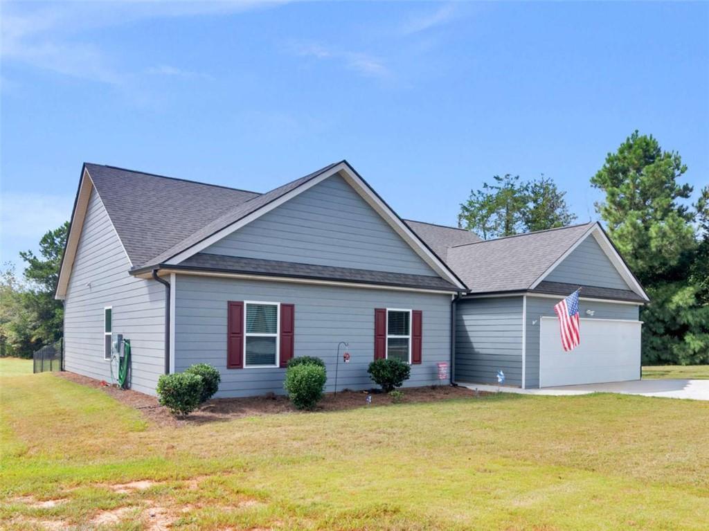 1299 Covered Bridge Road Covington, GA 30016 - Photo 1 of 1 a view of a house with backyard and glass windows