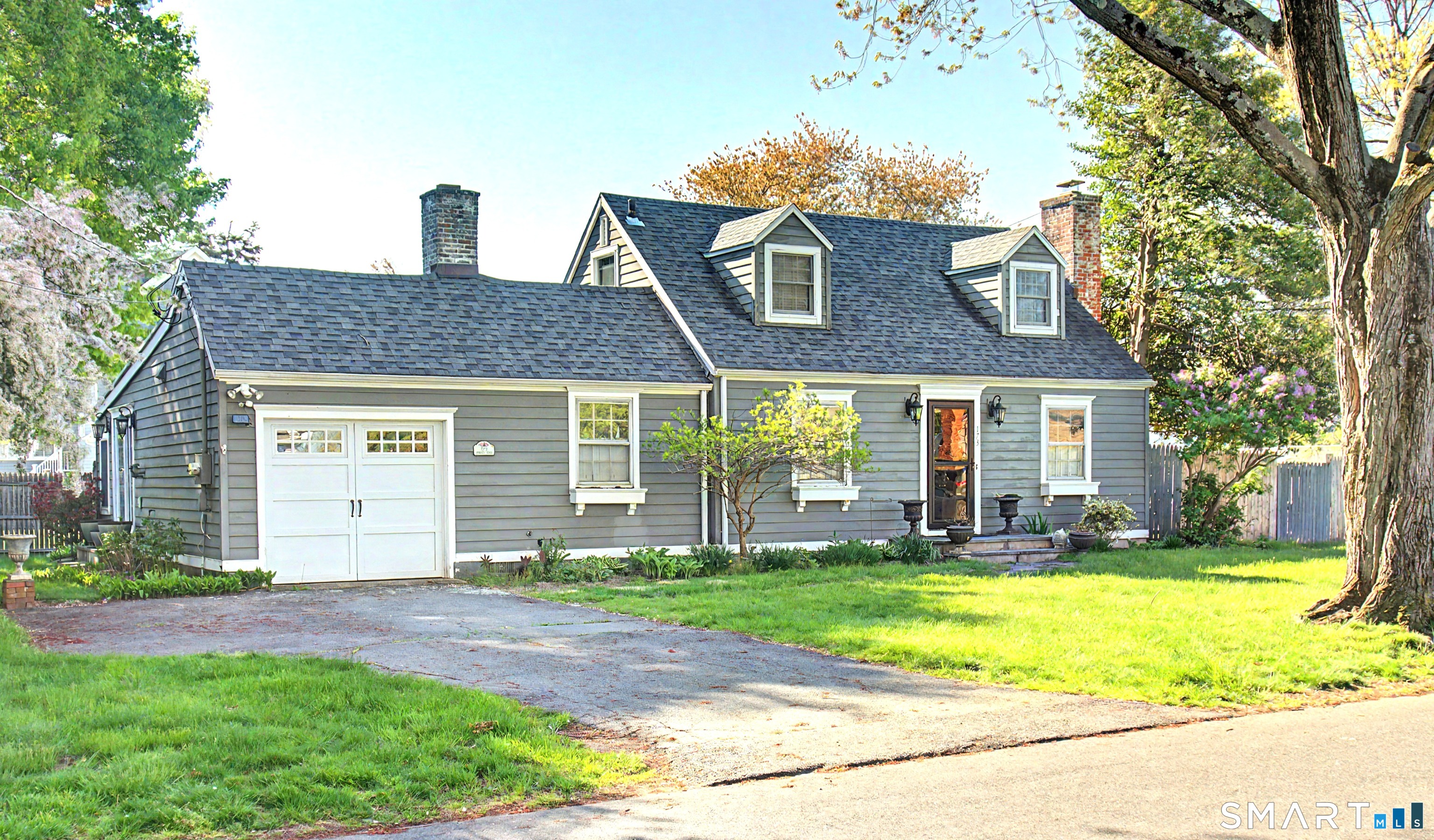 173 Puritan Road Fairfield, CT 06824 - Photo 1 of 19 a view of a house with a yard and plants