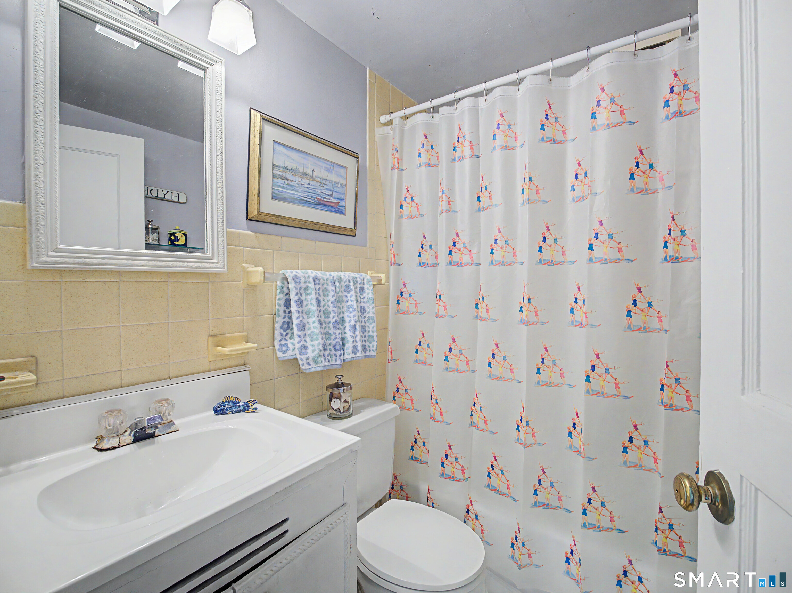 173 Puritan Road Fairfield, CT 06824 - Photo 16 of 19 a bathroom with a sink toilet and a mirror