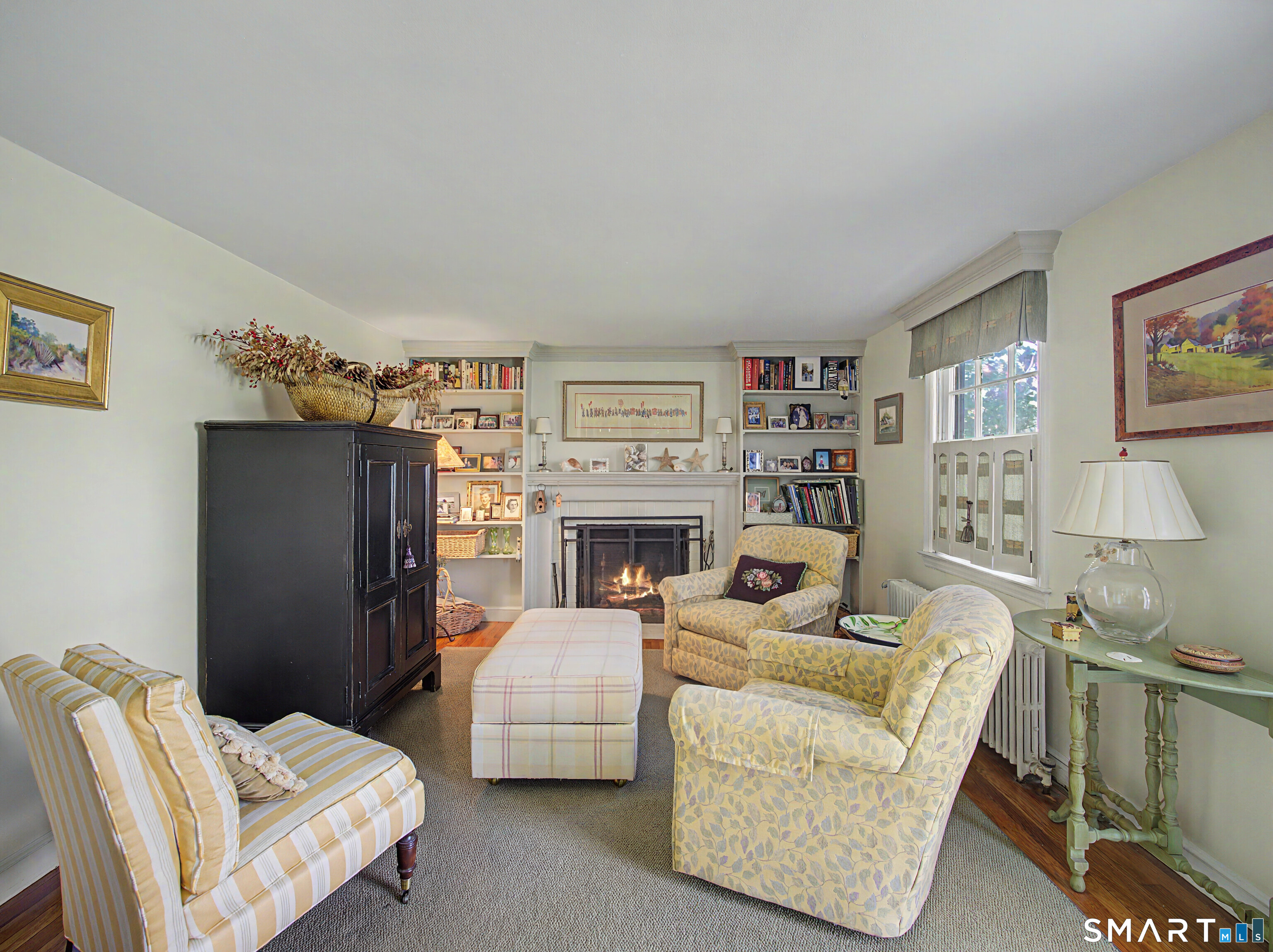 173 Puritan Road Fairfield, CT 06824 - Photo 3 of 19 a living room with furniture and a fireplace