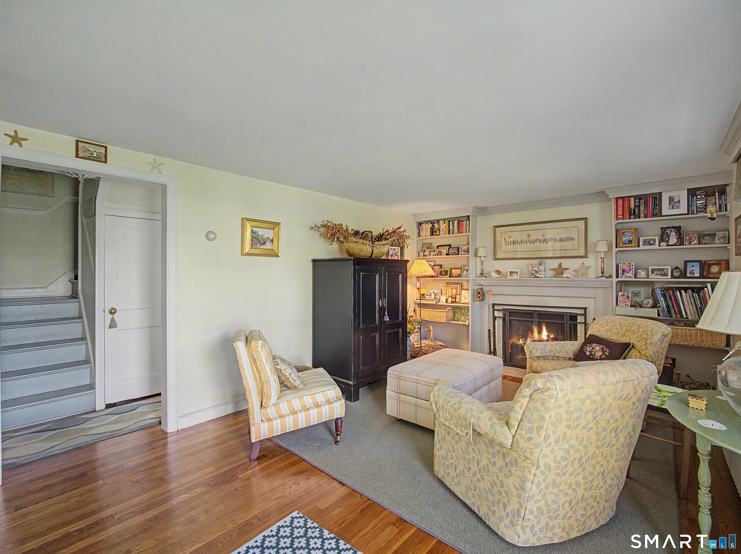 173 Puritan Road Fairfield, CT 06824 - Photo 4 of 19 a living room with furniture and a fireplace