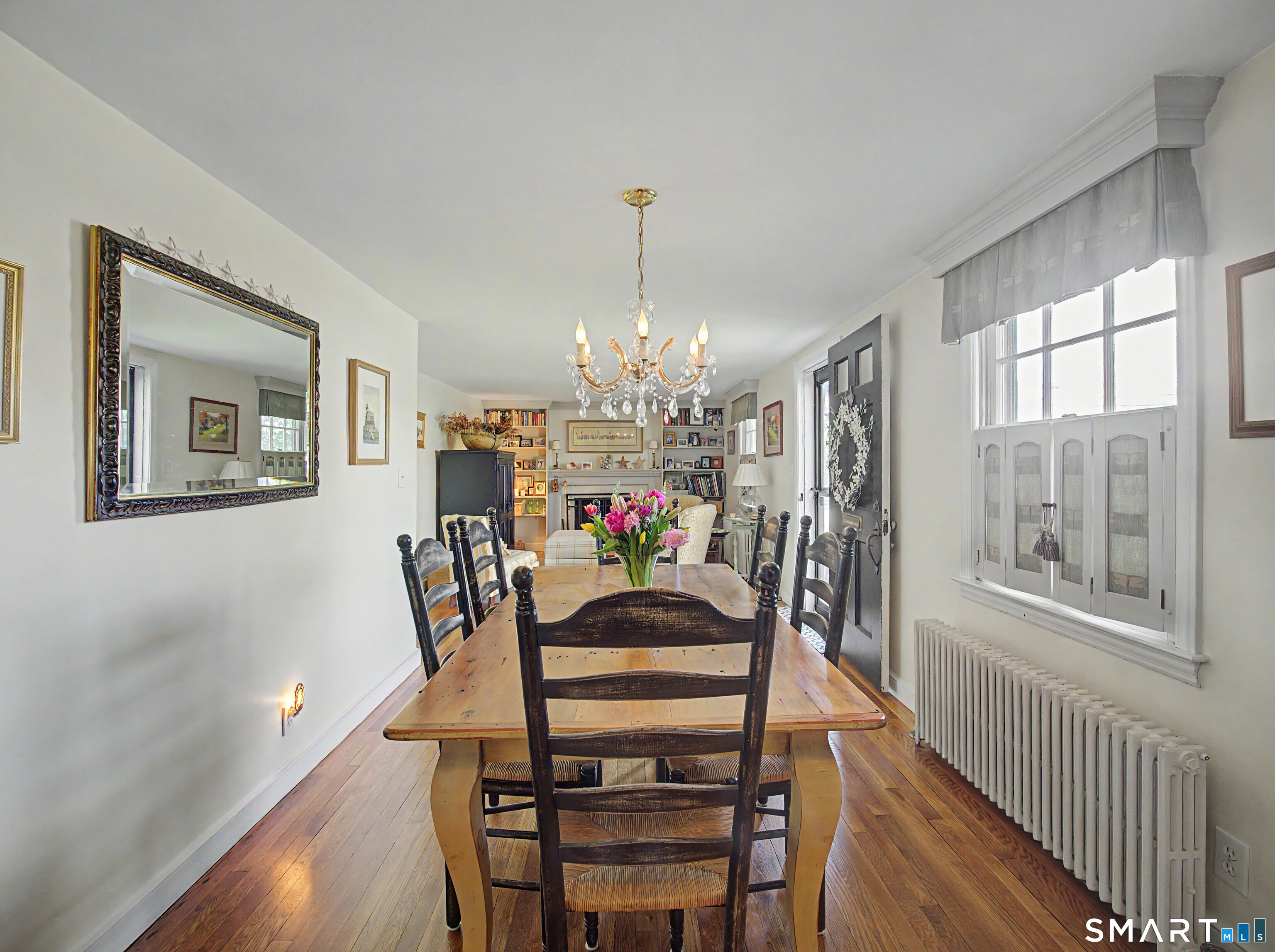 173 Puritan Road Fairfield, CT 06824 - Photo 6 of 19 a view of a dining room with furniture a chandelier and wooden floor