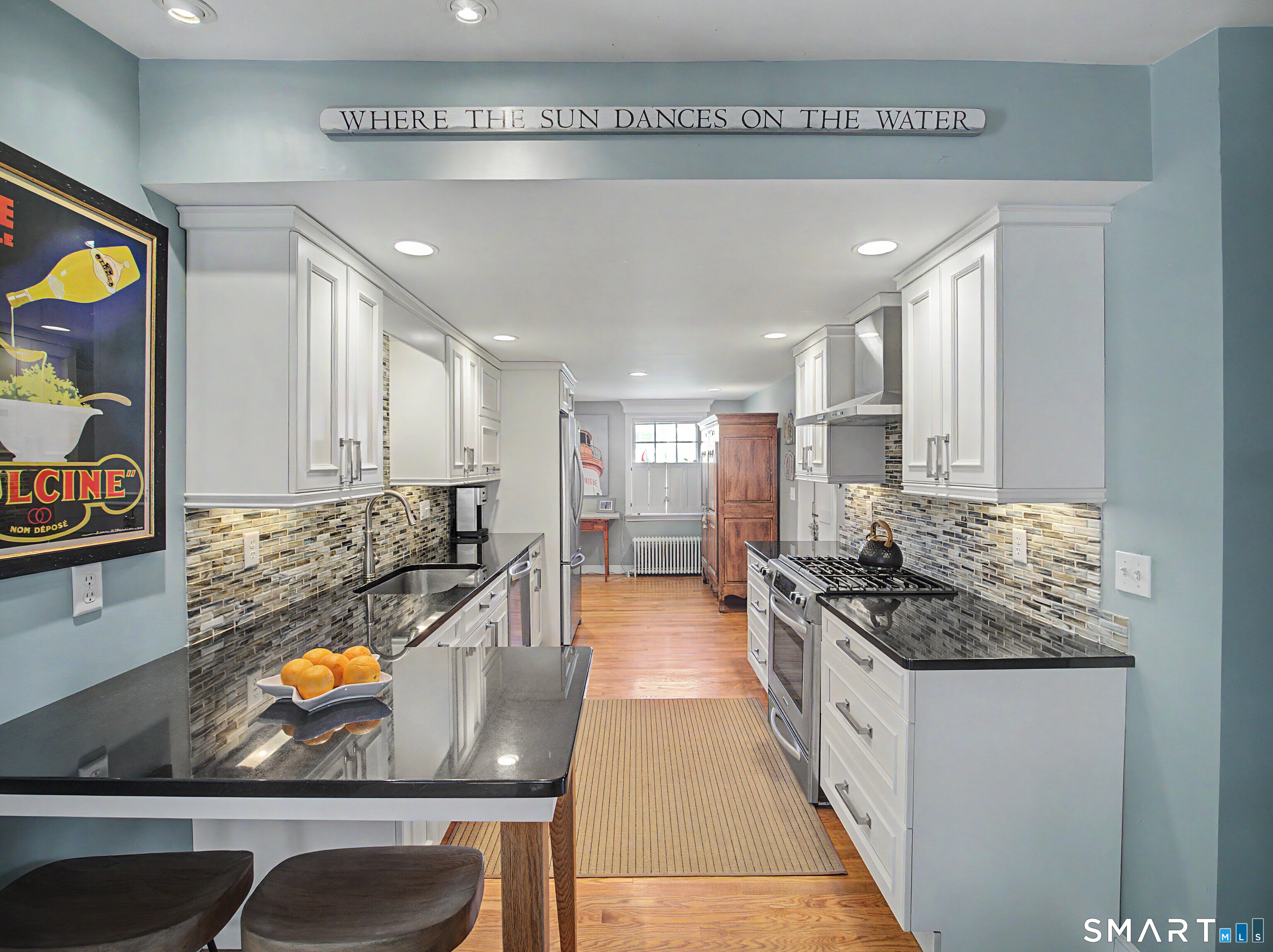 173 Puritan Road Fairfield, CT 06824 - Photo 7 of 19 a kitchen with stainless steel appliances granite countertop a stove and a refrigerator