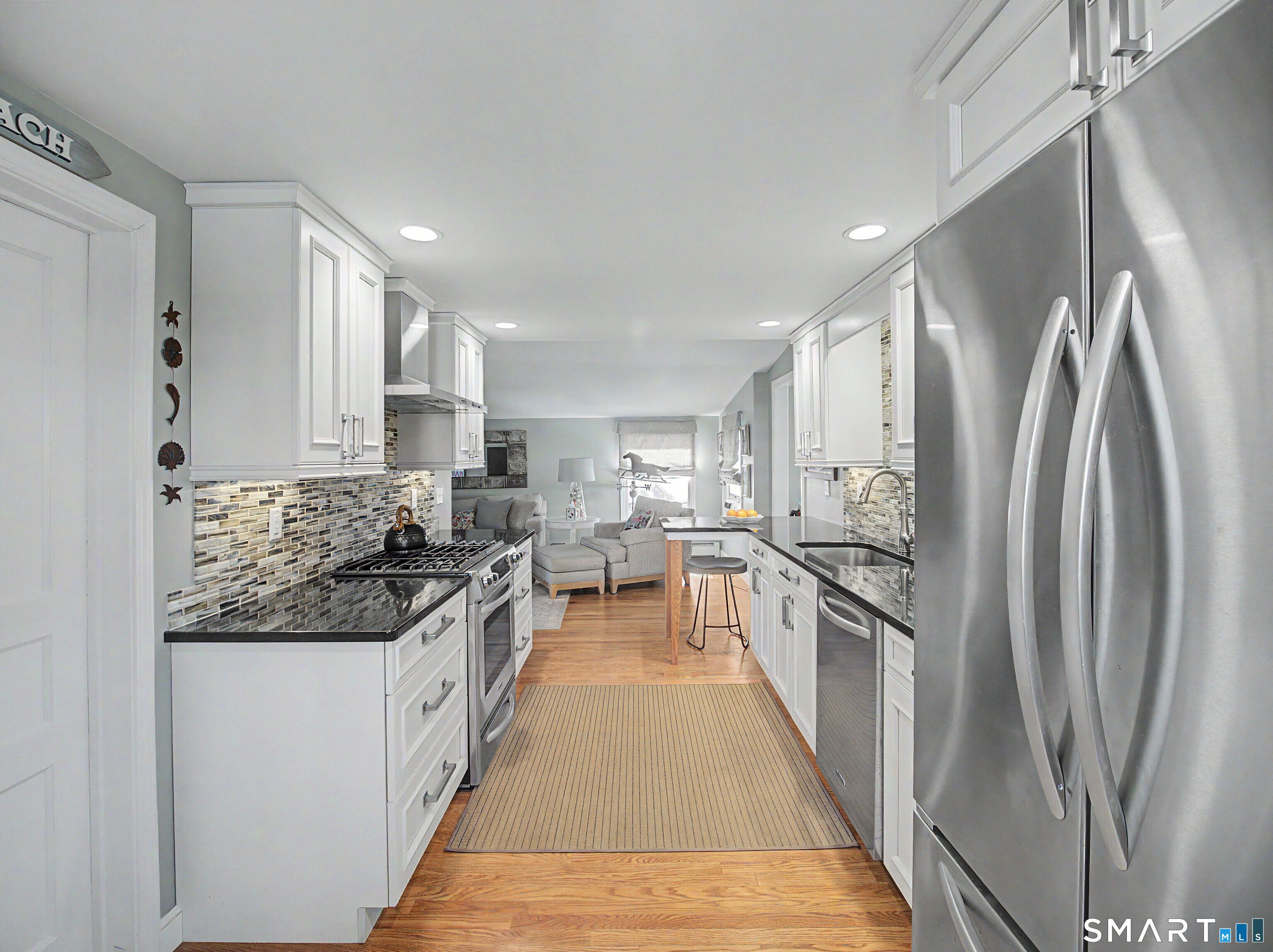 173 Puritan Road Fairfield, CT 06824 - Photo 8 of 19 a kitchen with stainless steel appliances granite countertop a refrigerator a stove and a sink