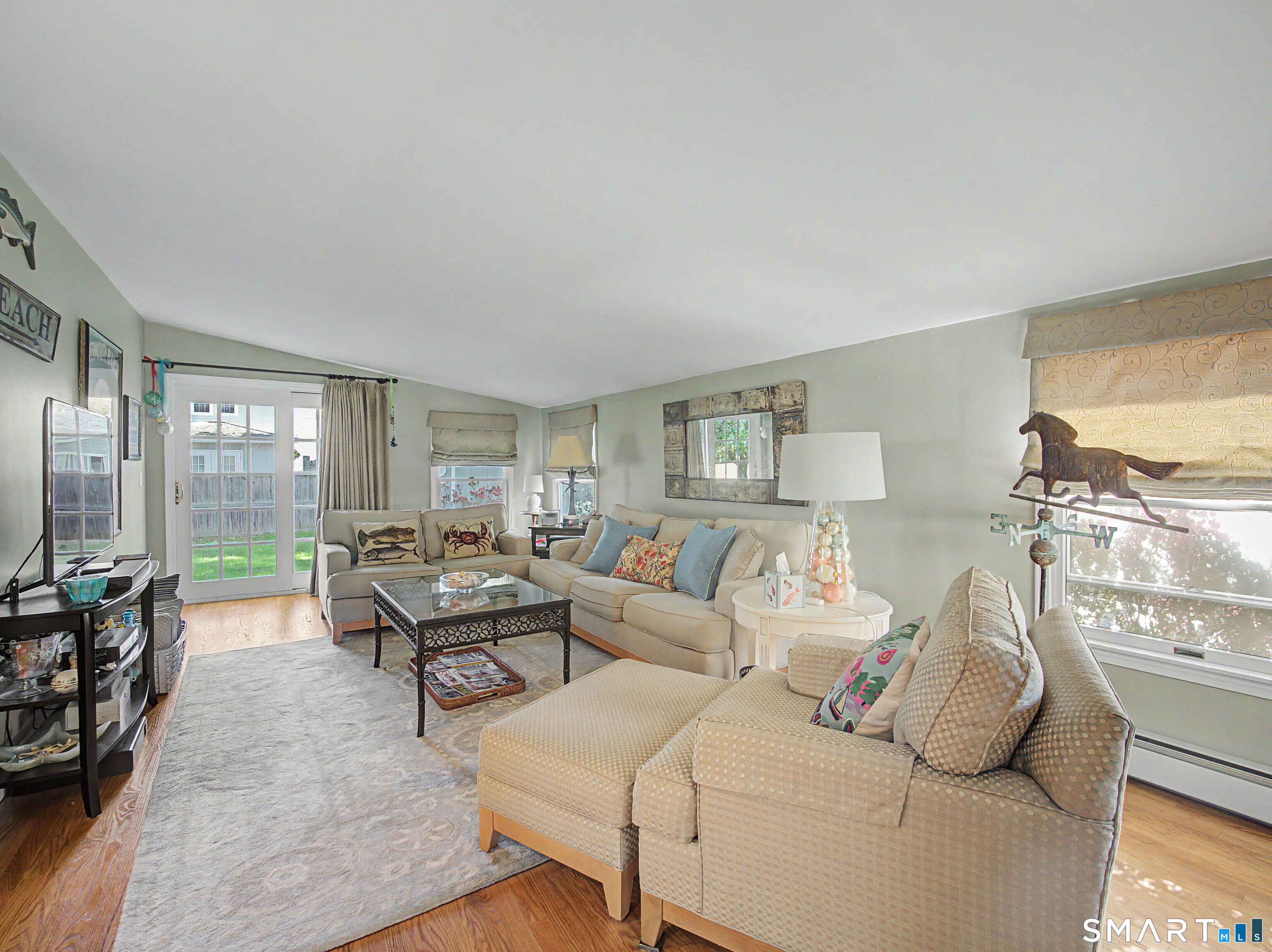 173 Puritan Road Fairfield, CT 06824 - Photo 10 of 19 a living room with furniture and a large window