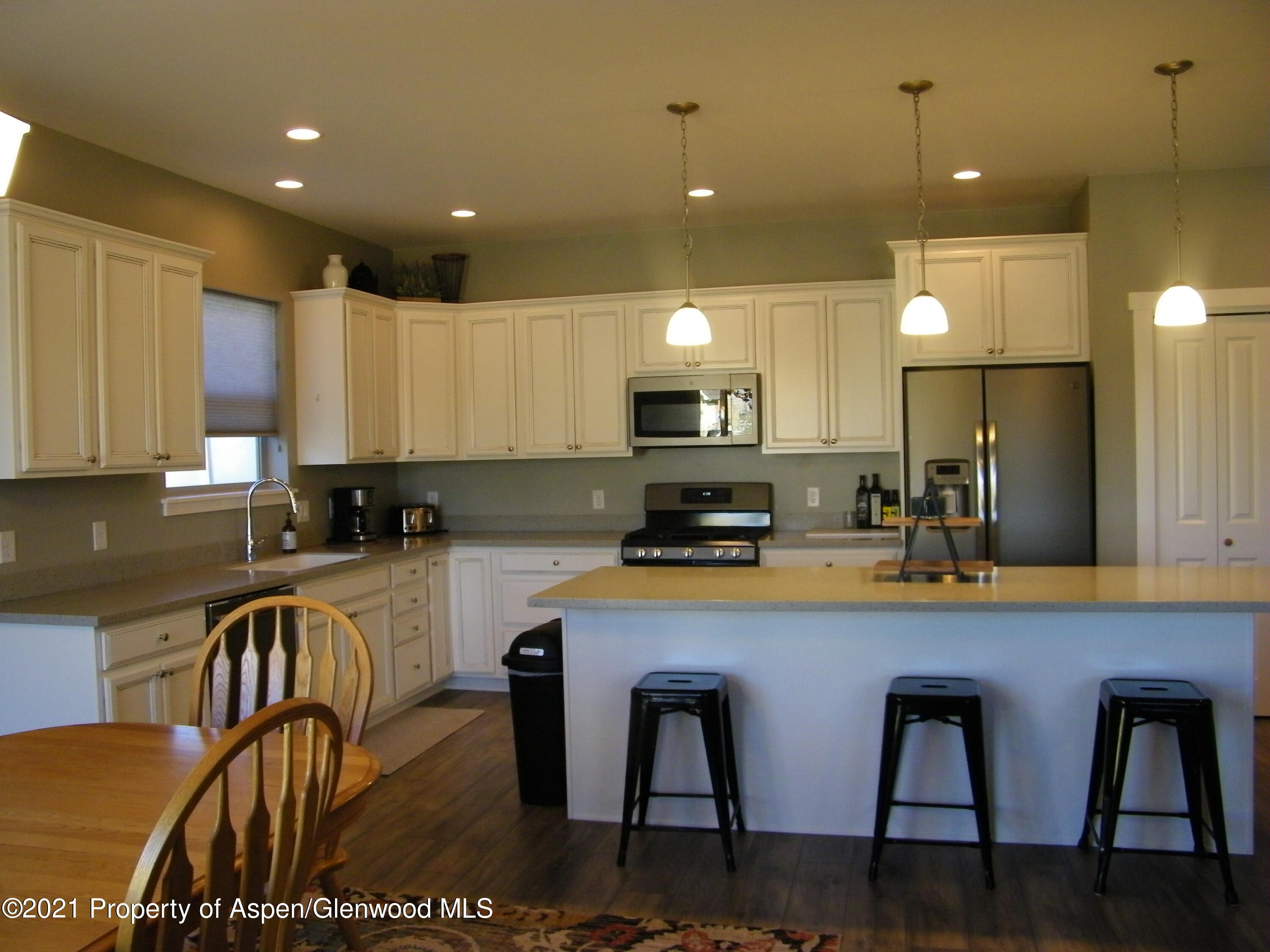 1717 Belgian Loop Silt, CO 81652 - Photo 3 of 16 a kitchen with a table chairs microwave and cabinets