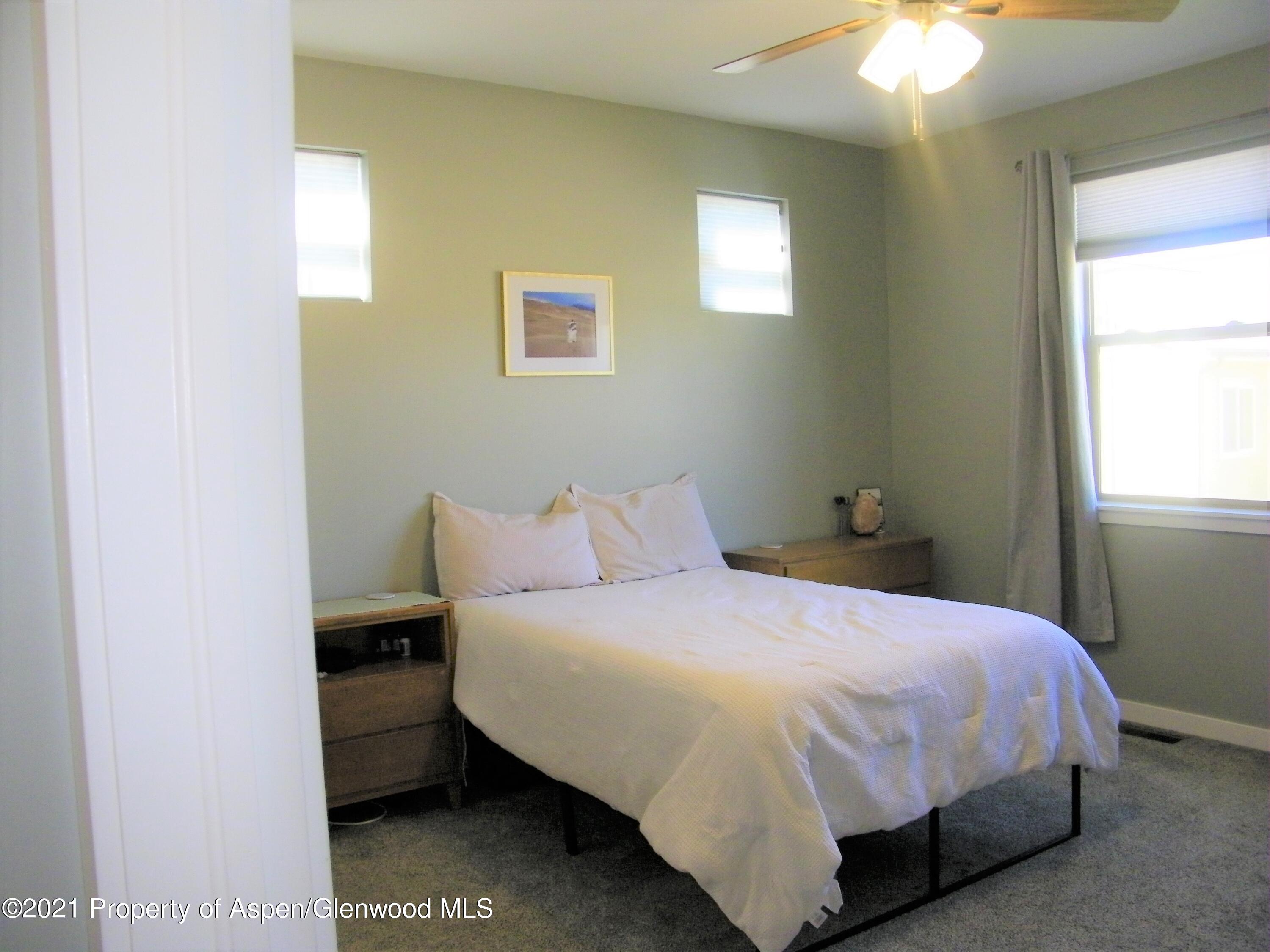 1717 Belgian Loop Silt, CO 81652 - Photo 8 of 16 a bedroom with a bed and a chandelier