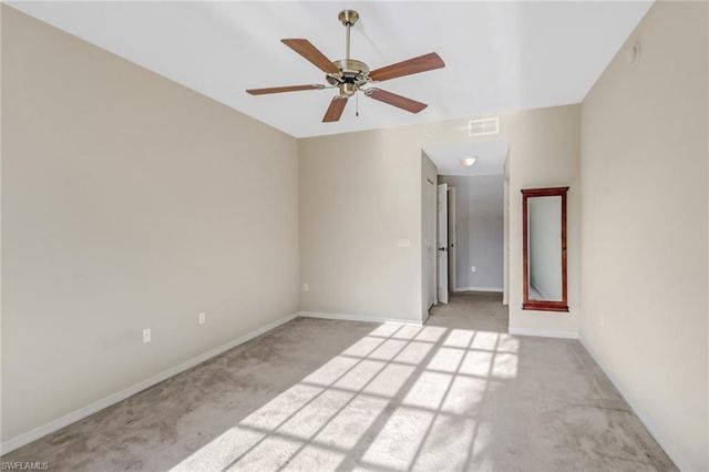 a view of a livingroom with a ceiling fan and wooden floor