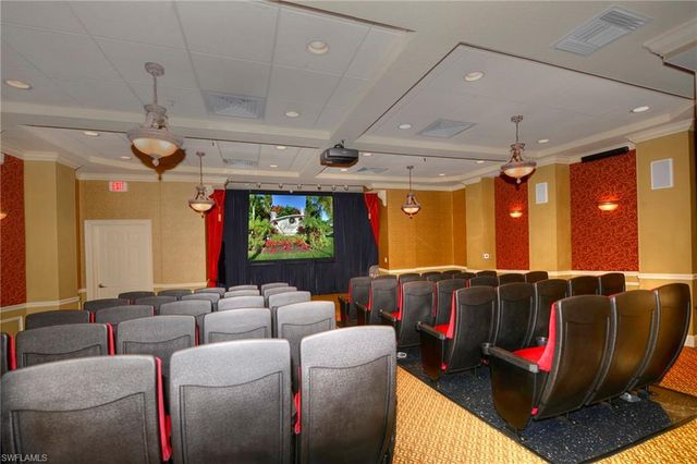 a media room with lots of chairs and a projector