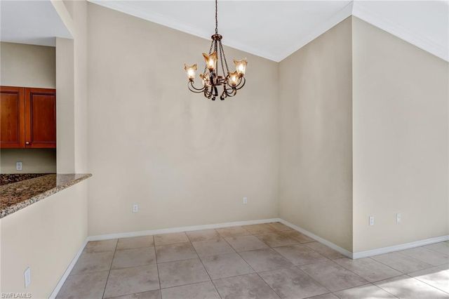 a view of kitchen with chandelier and refrigerator