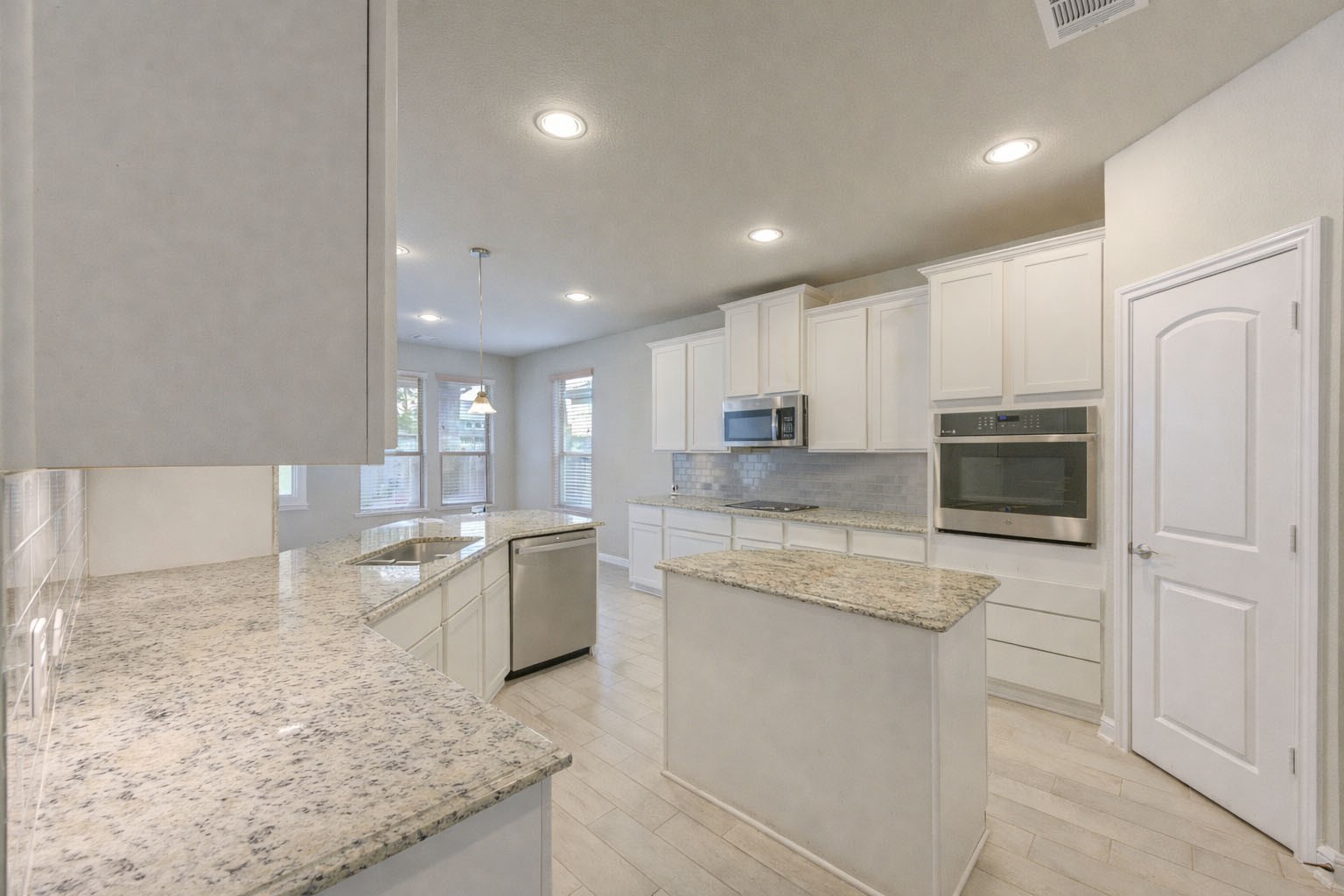 2910 Knotty Frst Drive Spring, TX 77373 - Photo 7 of 20 a open kitchen with granite countertop white cabinets and white appliances