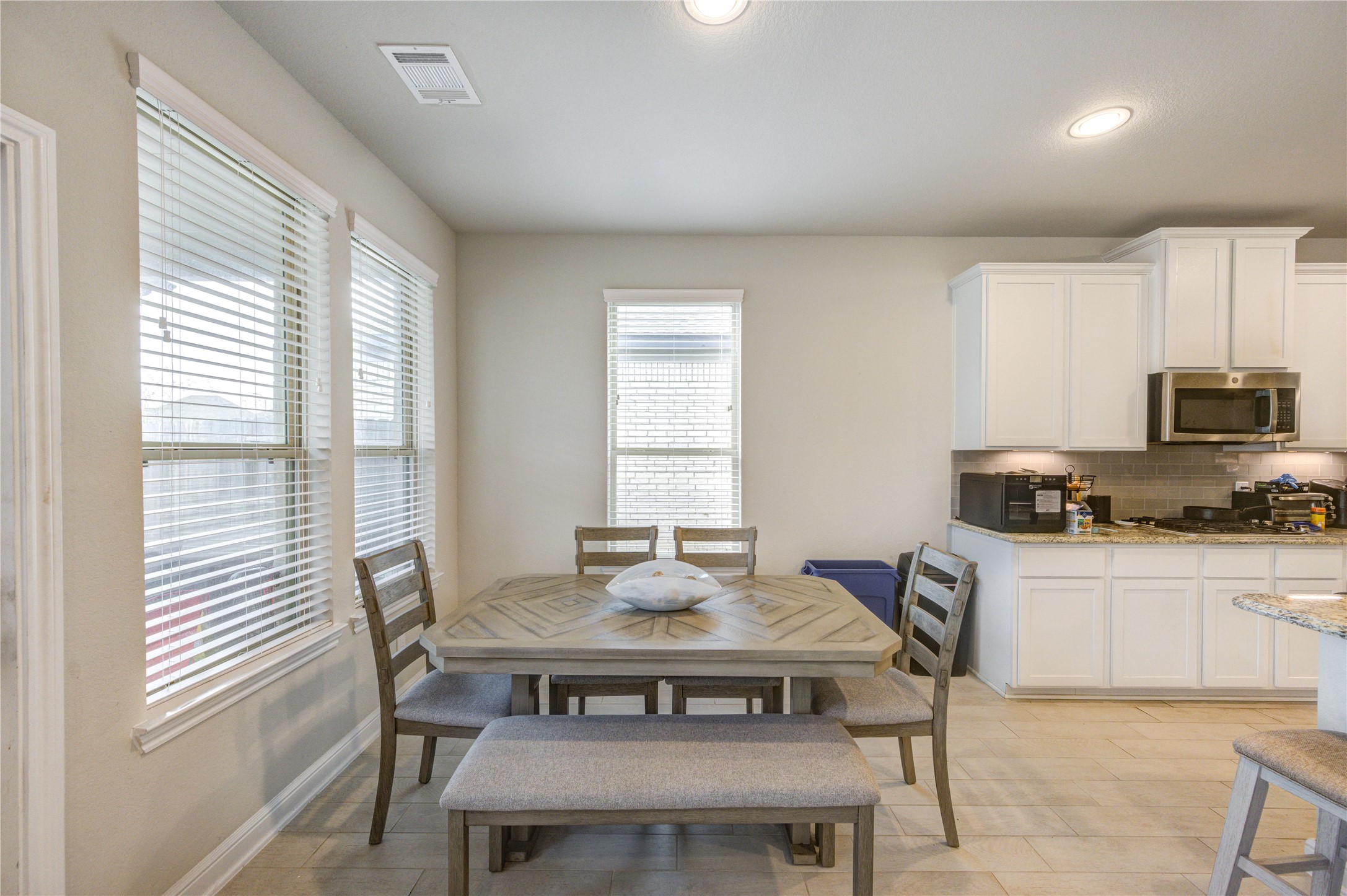 2910 Knotty Frst Drive Spring, TX 77373 - Photo 9 of 20 a kitchen with a table chairs a sink dishwasher window and cabinets