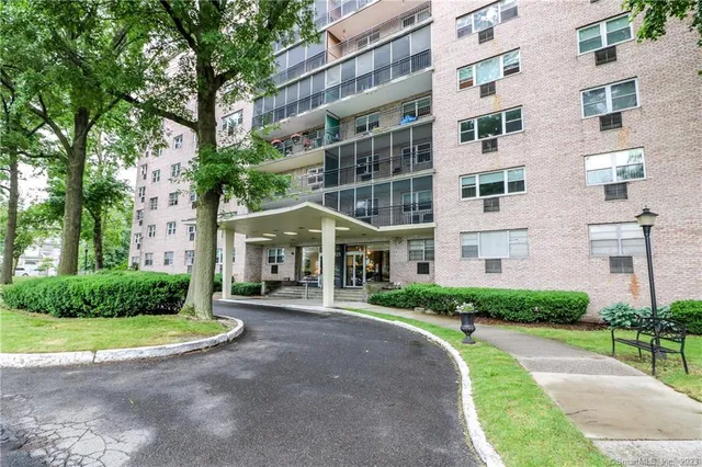 a front view of a residential apartment building with a yard
