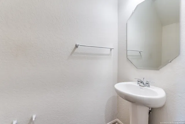 a bathroom with a sink and mirror