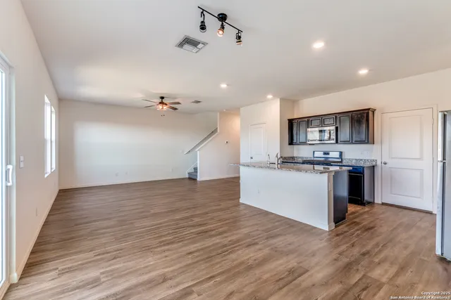 a view of kitchen with sink microwave and refrigerator