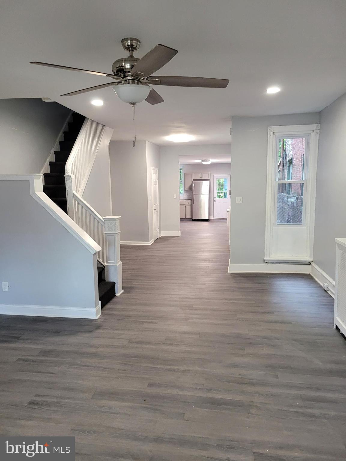 1422 Blavis Street Philadelphia, PA 19140 - Photo 4 of 20 a view of an empty room with wooden floor and a ceiling fan