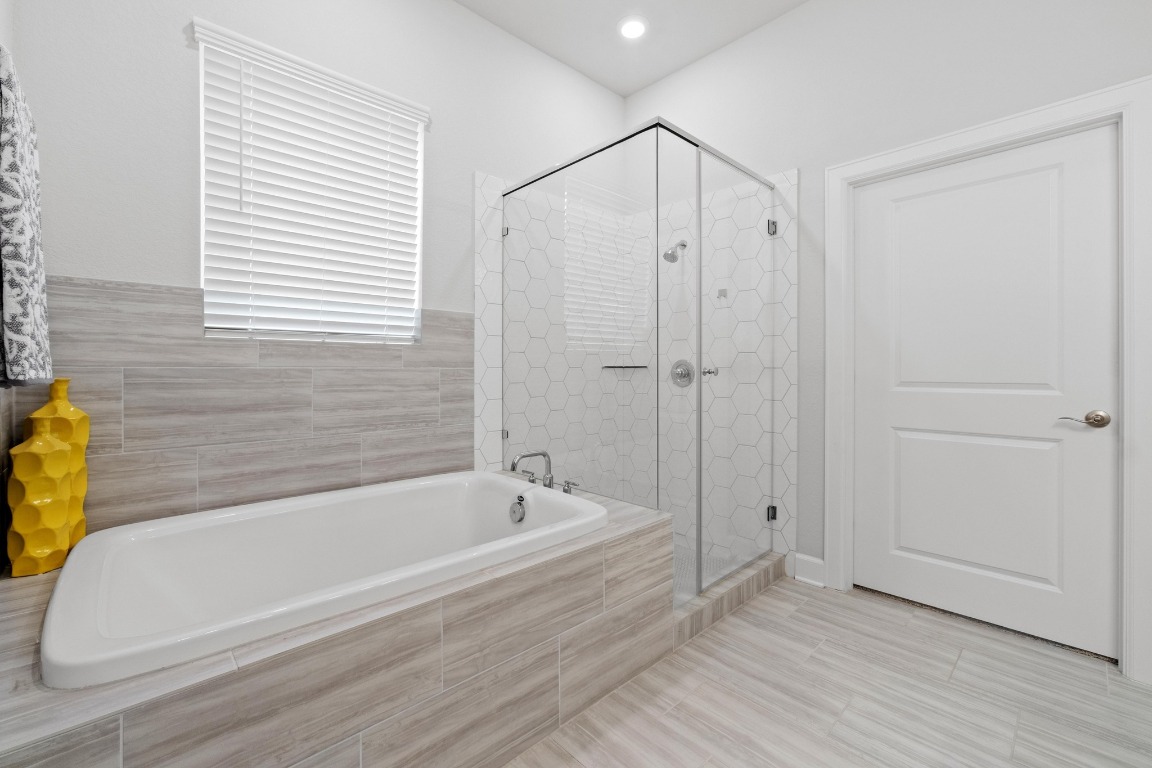 144 Monterey Oak Trail Georgetown, TX 78628 - Photo 14 of 28 a bathroom with a bathtub and a shower