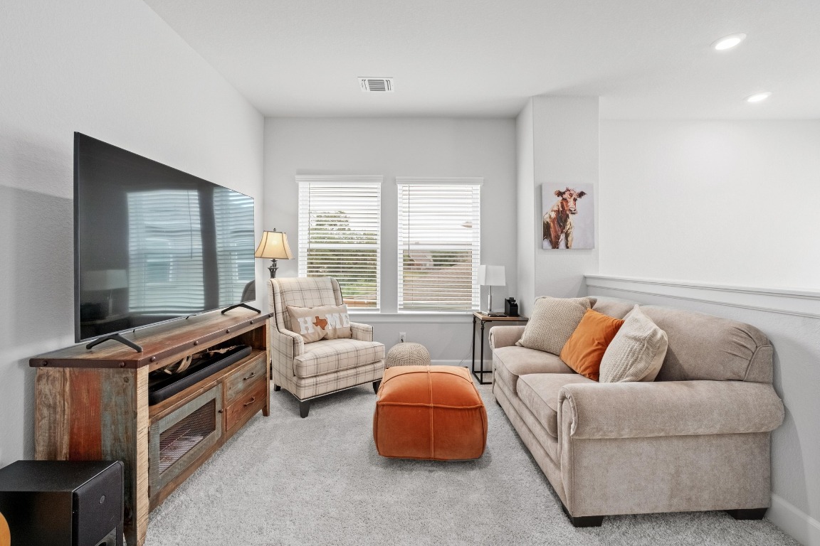144 Monterey Oak Trail Georgetown, TX 78628 - Photo 16 of 28 a living room with furniture and a flat screen tv