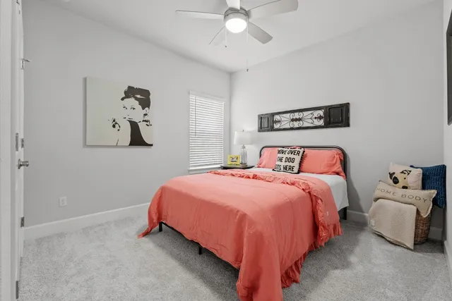 a bedroom with a bed and ceiling fan