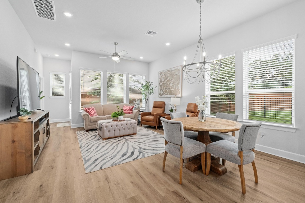 144 Monterey Oak Trail Georgetown, TX 78628 - Photo 3 of 28 a living room with furniture a flat screen tv and large windows