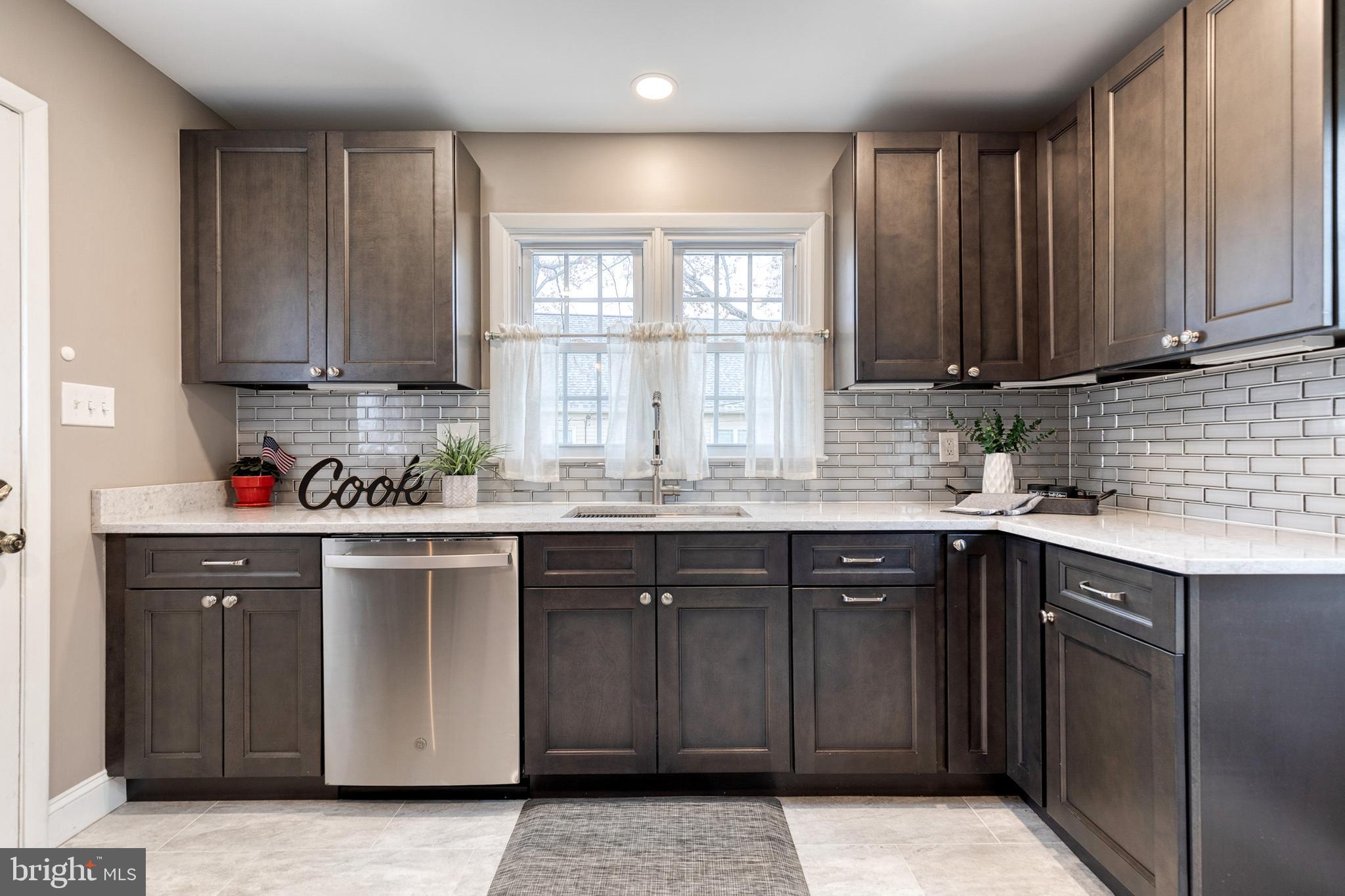 1302 Black Friars Road Baltimore, MD 21228 - Photo 11 of 38 a kitchen with stainless steel appliances granite countertop a sink stove and cabinets