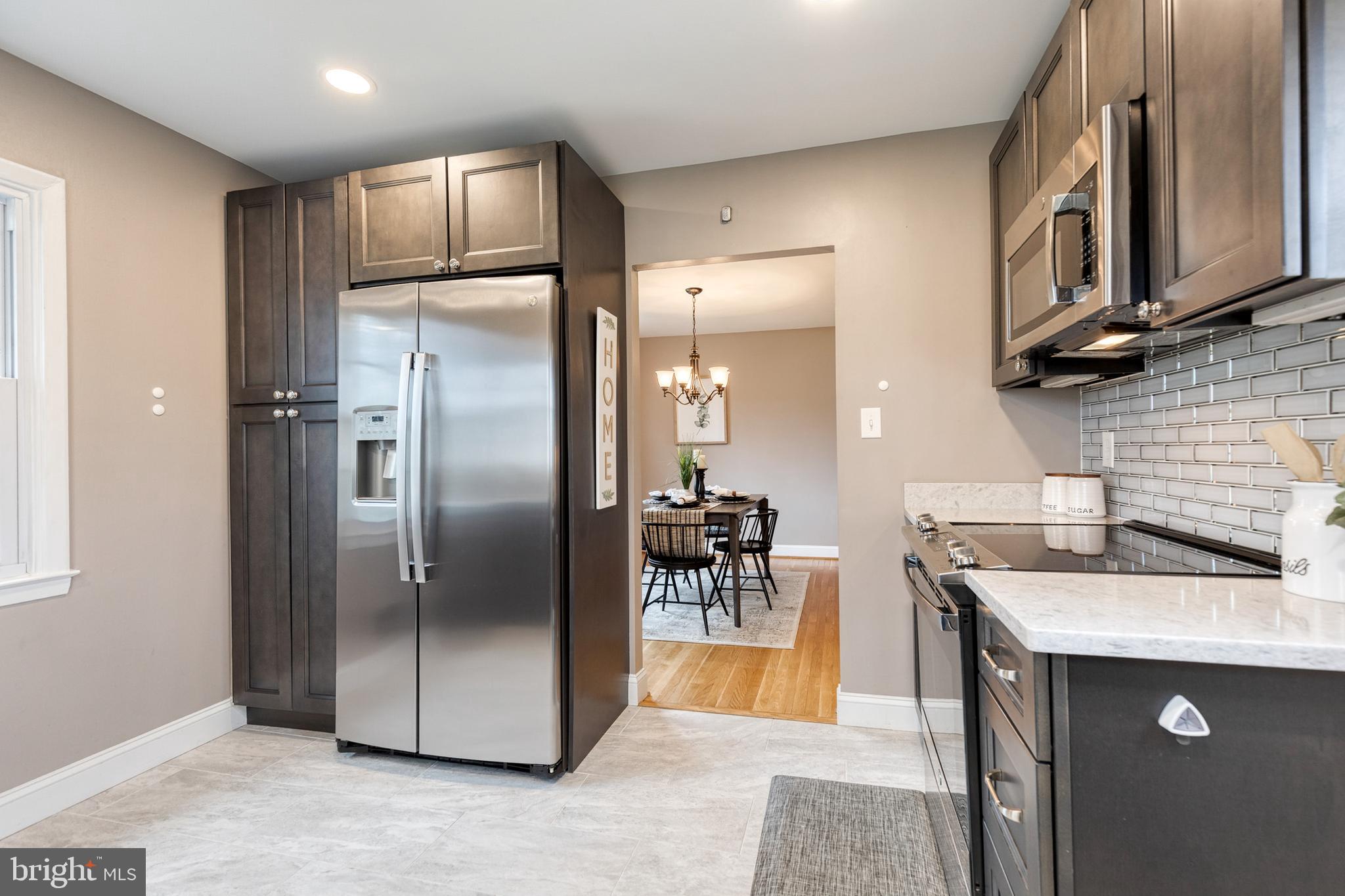 1302 Black Friars Road Baltimore, MD 21228 - Photo 12 of 38 a kitchen with stainless steel appliances granite countertop a refrigerator a sink a stove and a sink