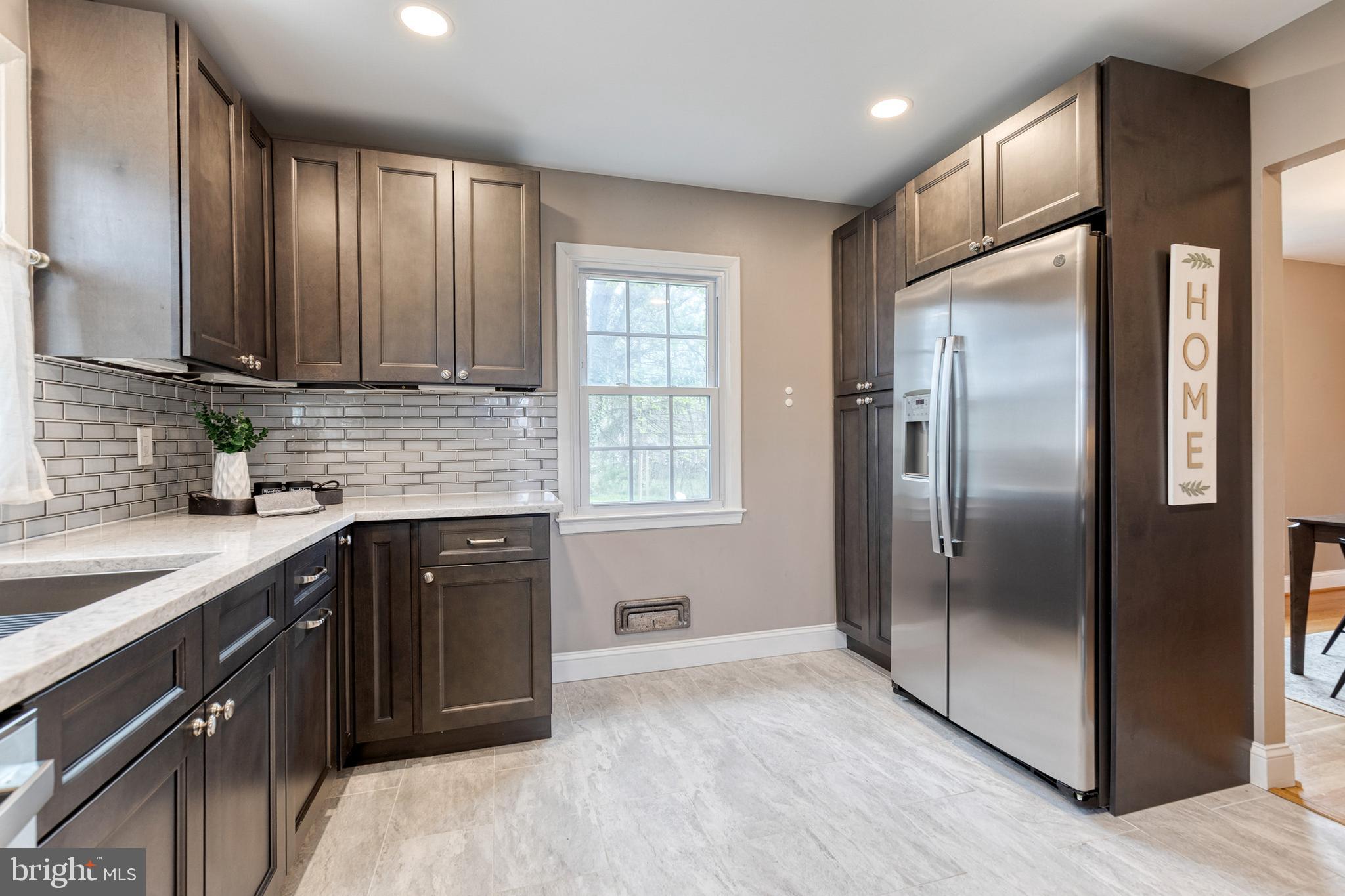 1302 Black Friars Road Baltimore, MD 21228 - Photo 13 of 38 a kitchen with stainless steel appliances granite countertop a refrigerator a sink a stove and cabinets