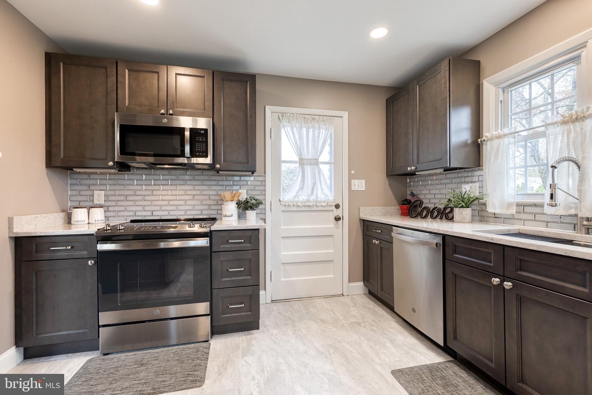 1302 Black Friars Road Baltimore, MD 21228 - Photo 15 of 38 a kitchen with stainless steel appliances granite countertop a stove microwave and sink