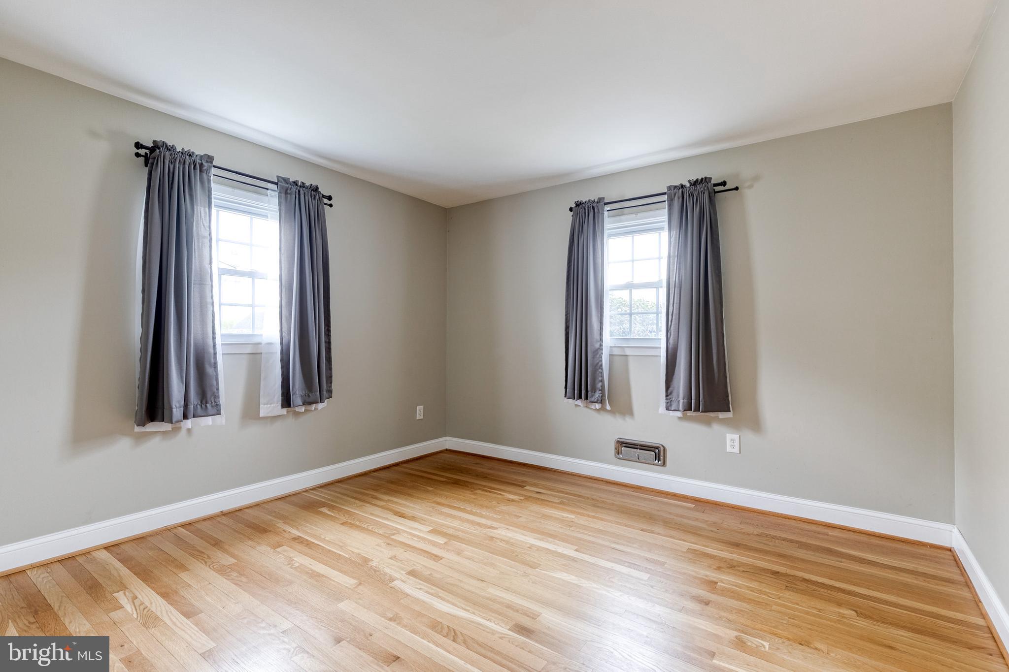 1302 Black Friars Road Baltimore, MD 21228 - Photo 18 of 38 a view of an empty room with wooden floor and a window