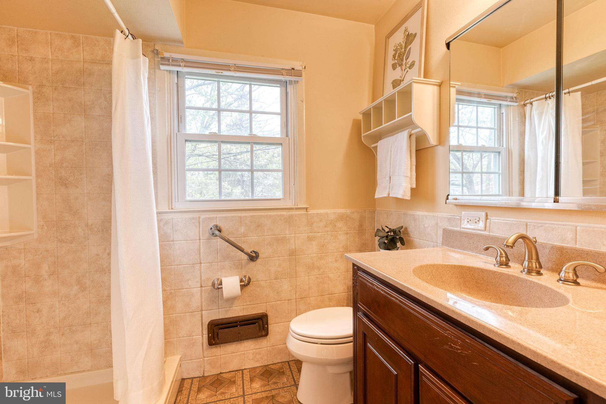 1302 Black Friars Road Baltimore, MD 21228 - Photo 19 of 38 a bathroom with a sink a toilet and a bathtub