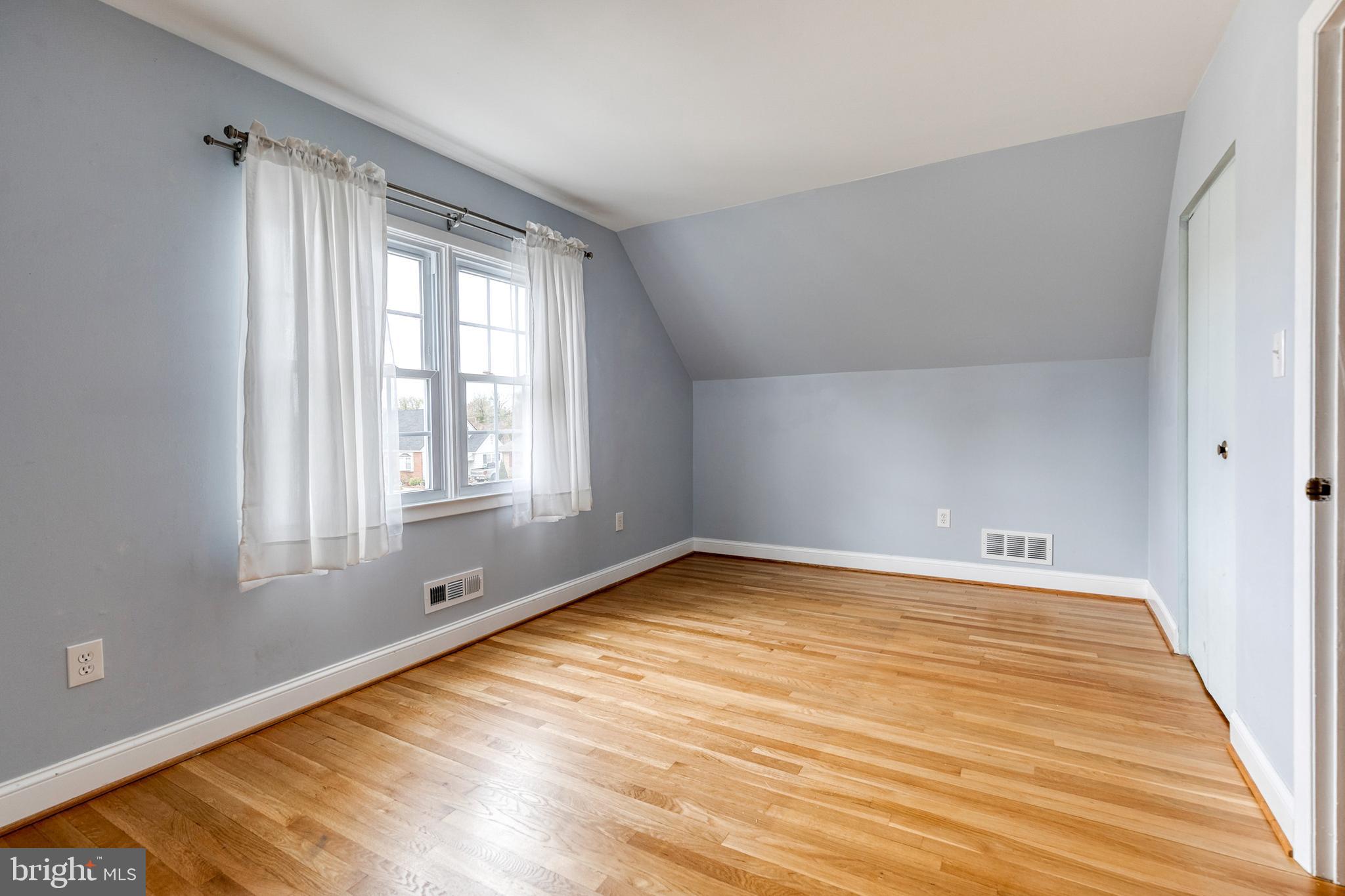 1302 Black Friars Road Baltimore, MD 21228 - Photo 23 of 38 a view of an empty room with wooden floor and a window