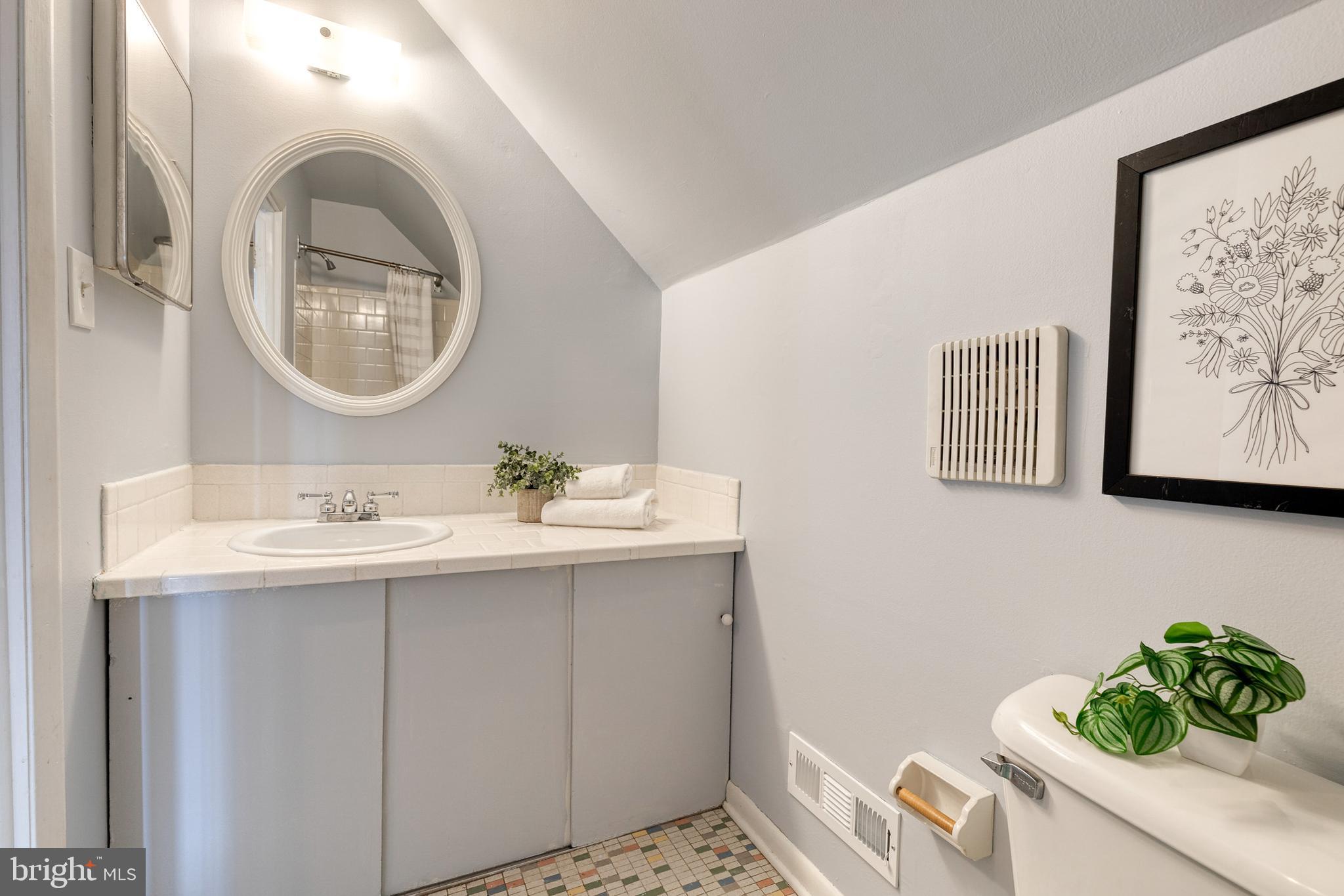 1302 Black Friars Road Baltimore, MD 21228 - Photo 25 of 38 a bathroom with a sink and a mirror