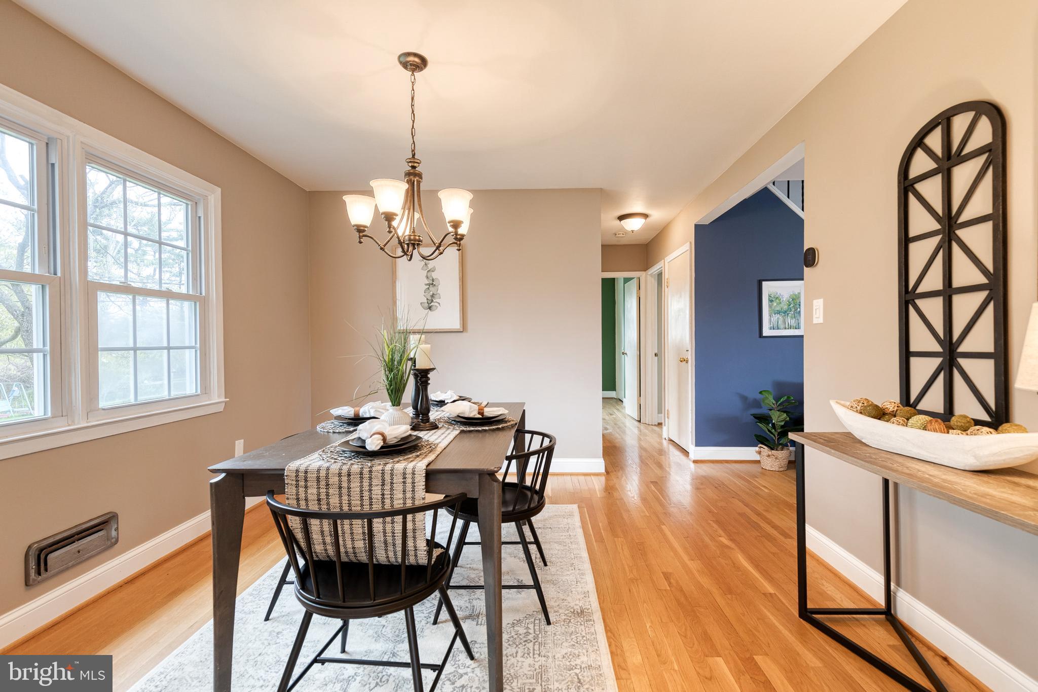 1302 Black Friars Road Baltimore, MD 21228 - Photo 9 of 38 a dining room with furniture a chandelier and wooden floor