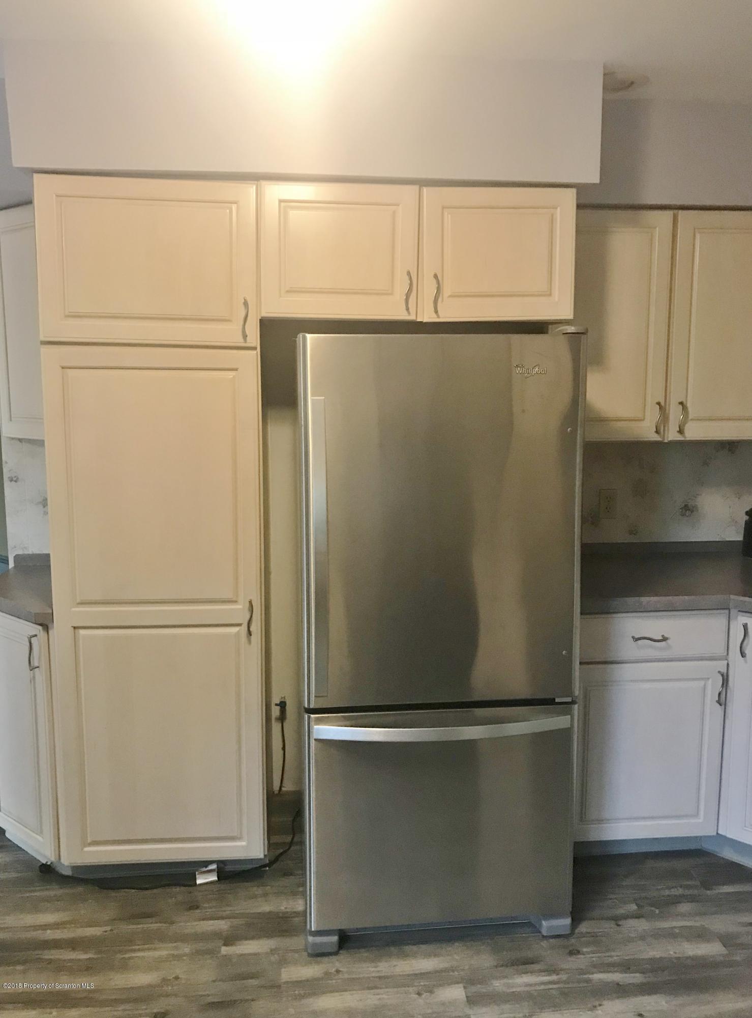 20 Ridgeview Drive Scranton, PA 18504 - Photo 12 of 39 a white refrigerator freezer and a microwave sitting in a kitchen