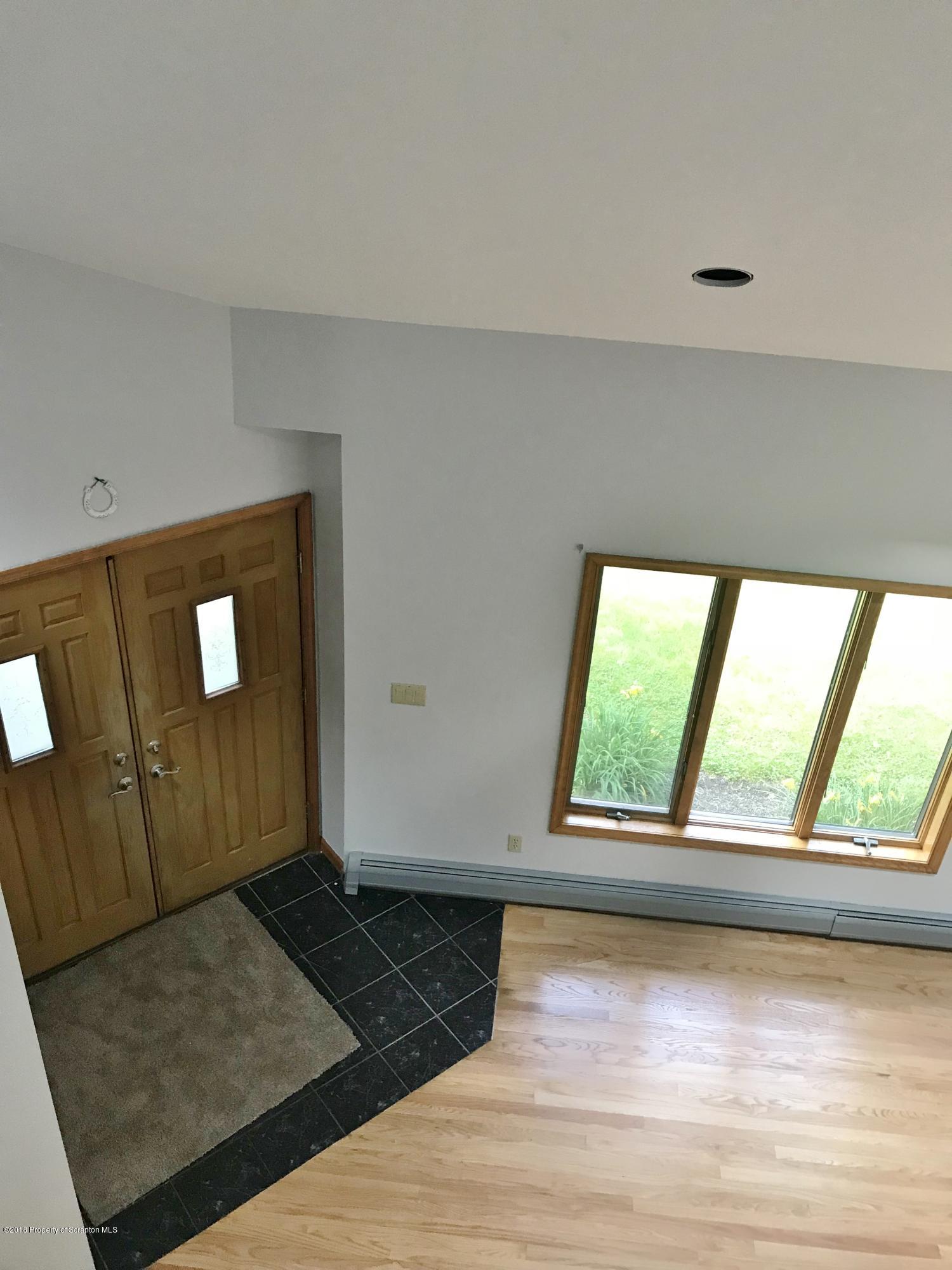 20 Ridgeview Drive Scranton, PA 18504 - Photo 19 of 39 a view of an empty room with wooden floor and a window