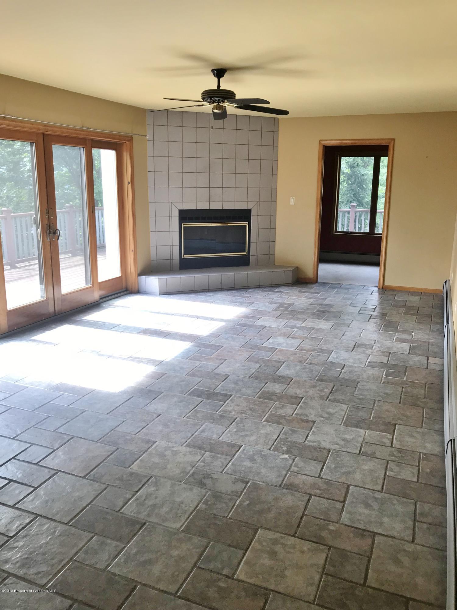 20 Ridgeview Drive Scranton, PA 18504 - Photo 2 of 39 a view of an empty room with a fireplace and a window