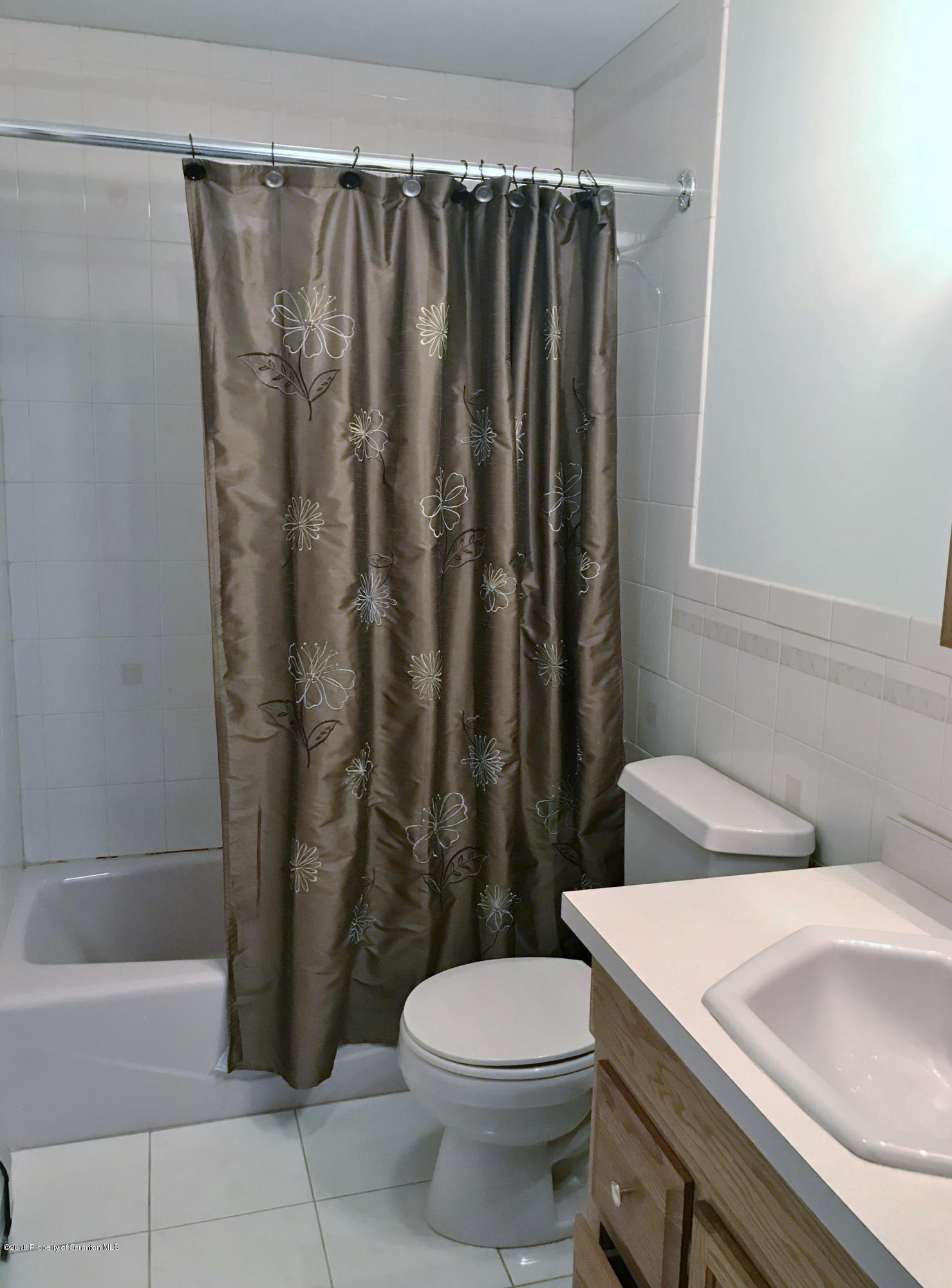 20 Ridgeview Drive Scranton, PA 18504 - Photo 27 of 39 a bathroom with a sink a toilet and shower