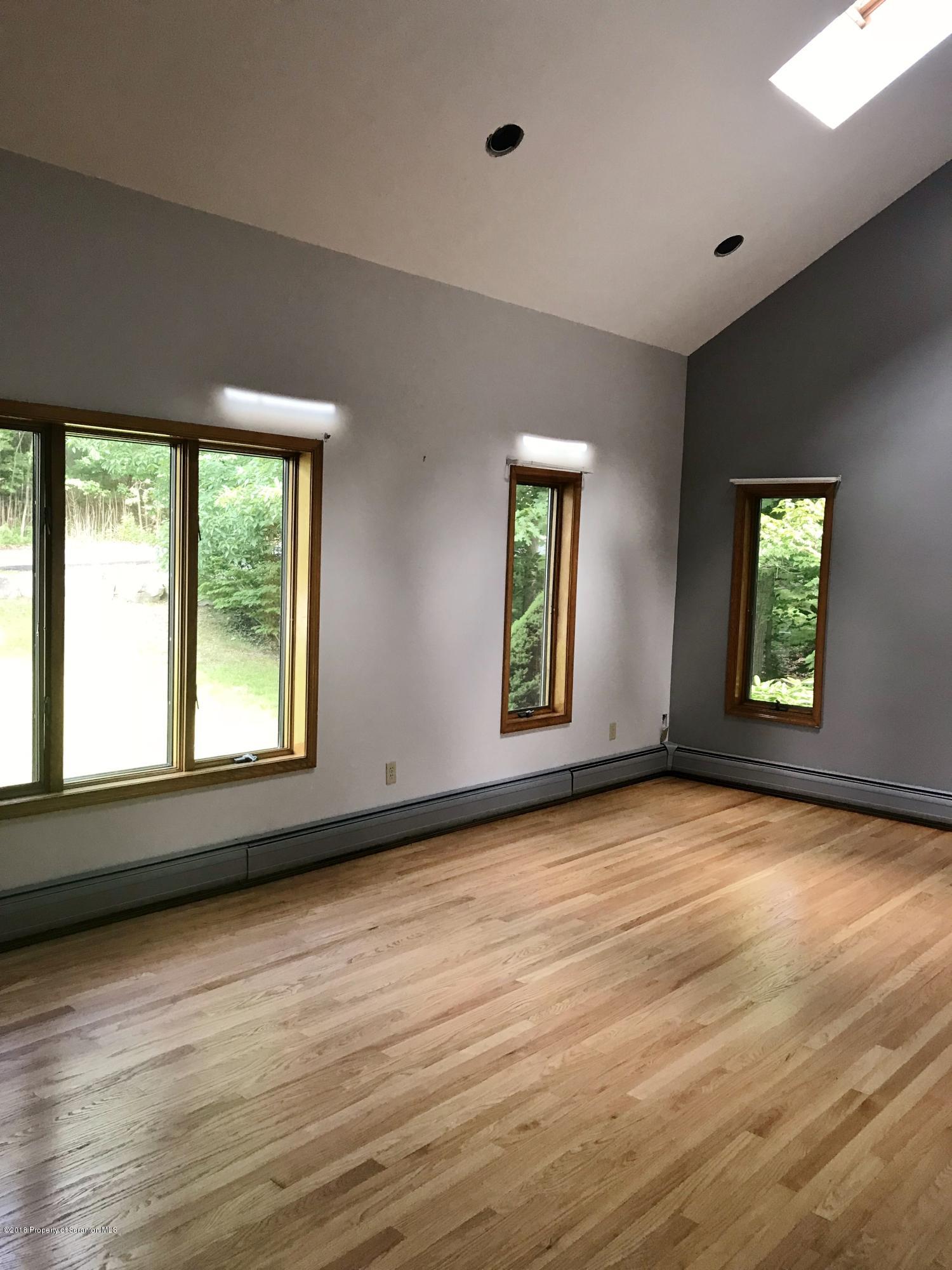 20 Ridgeview Drive Scranton, PA 18504 - Photo 3 of 39 a view of an empty room with a window and wooden floor