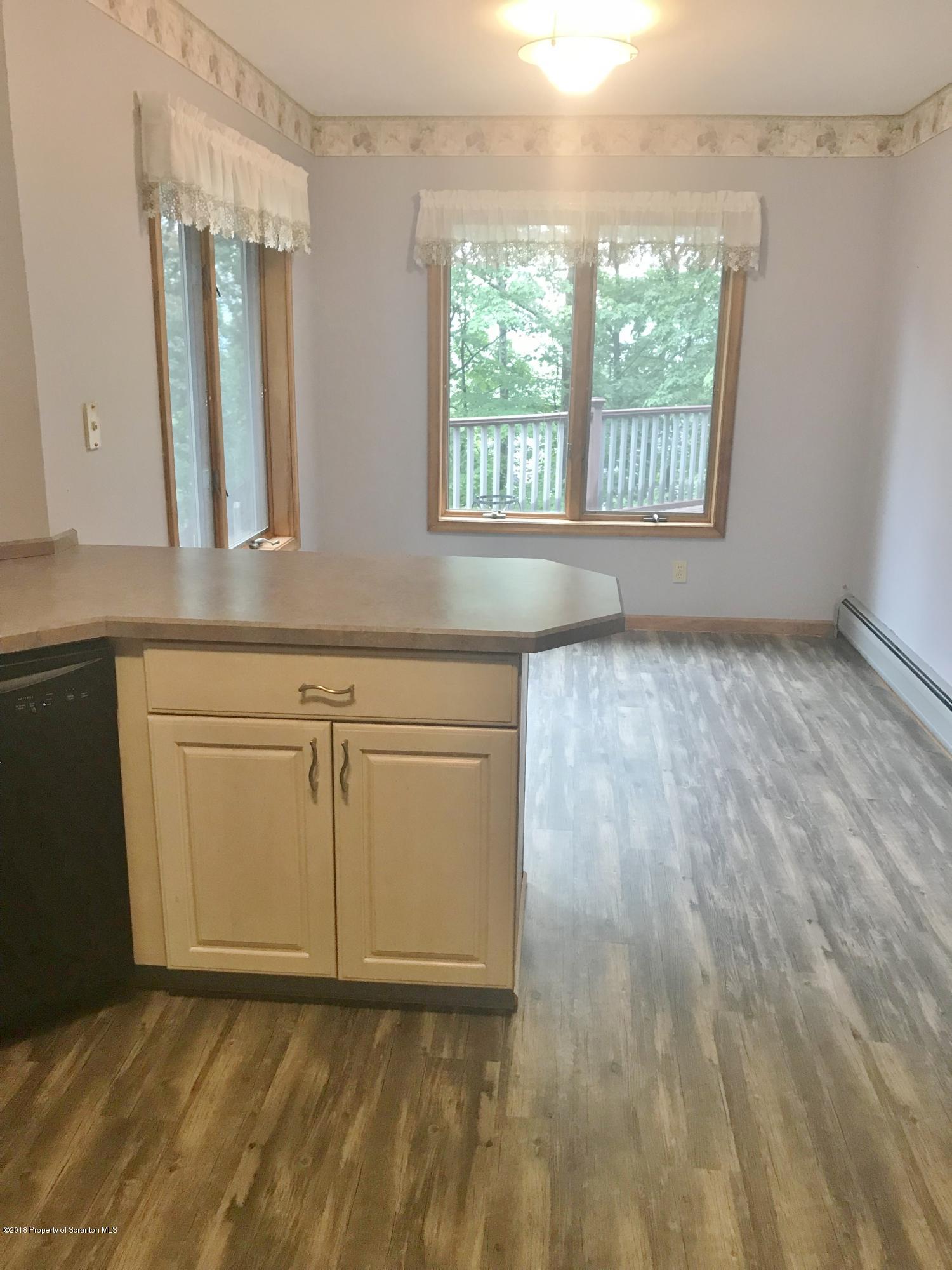 20 Ridgeview Drive Scranton, PA 18504 - Photo 8 of 39 a view of an empty room with window and hardwood floor
