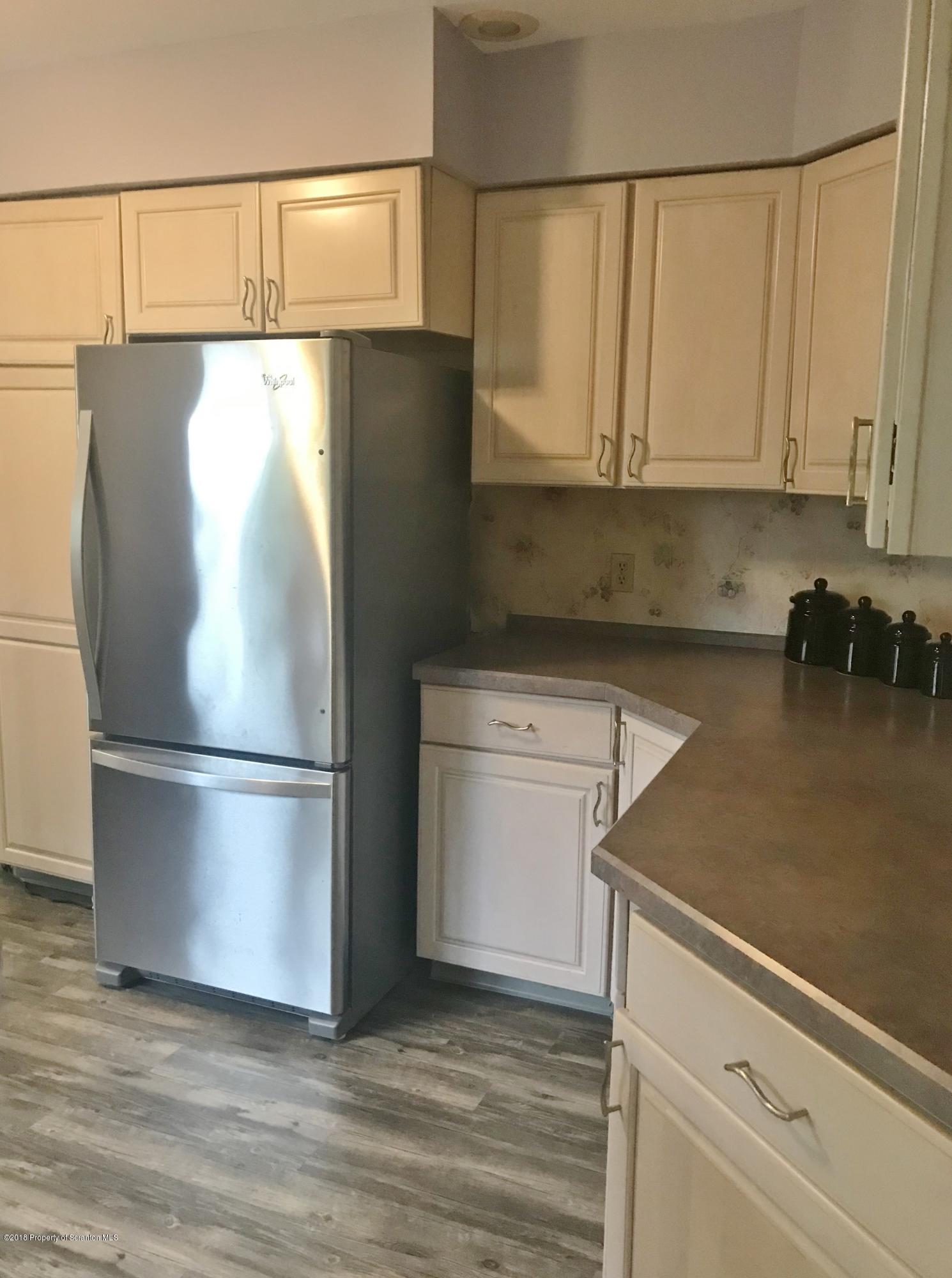 20 Ridgeview Drive Scranton, PA 18504 - Photo 9 of 39 a white refrigerator freezer and a stove sitting inside of a kitchen