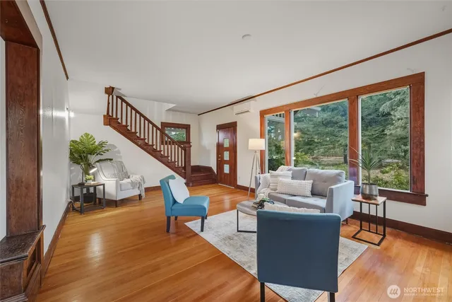 a living room with furniture and a wooden floor