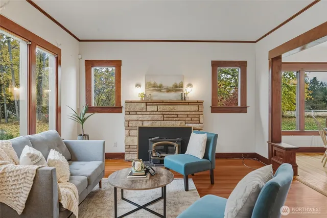 a living room with furniture fireplace and a large window