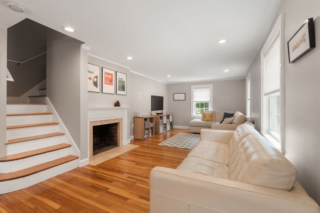 46 MacArthur Road Stoneham, MA 02180 - Photo 22 of 41 a living room with furniture a fireplace and a flat screen tv