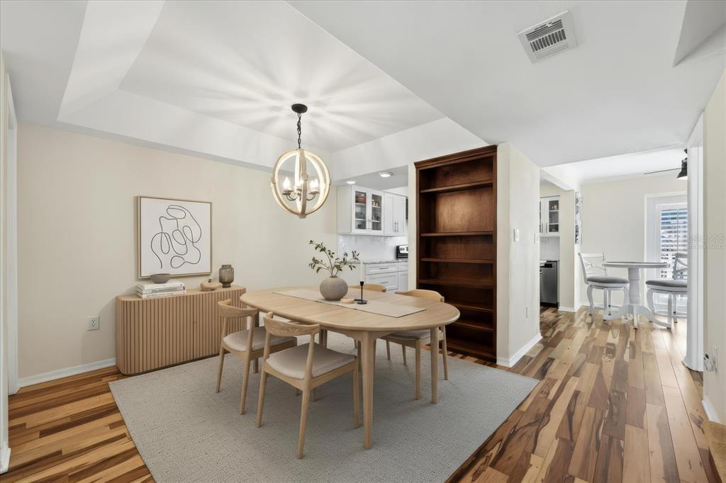9170 Blind Pass Road St. Pete Beach, FL 33706 - Photo 12 of 58 a view of a dining room with furniture wooden floor and a rug