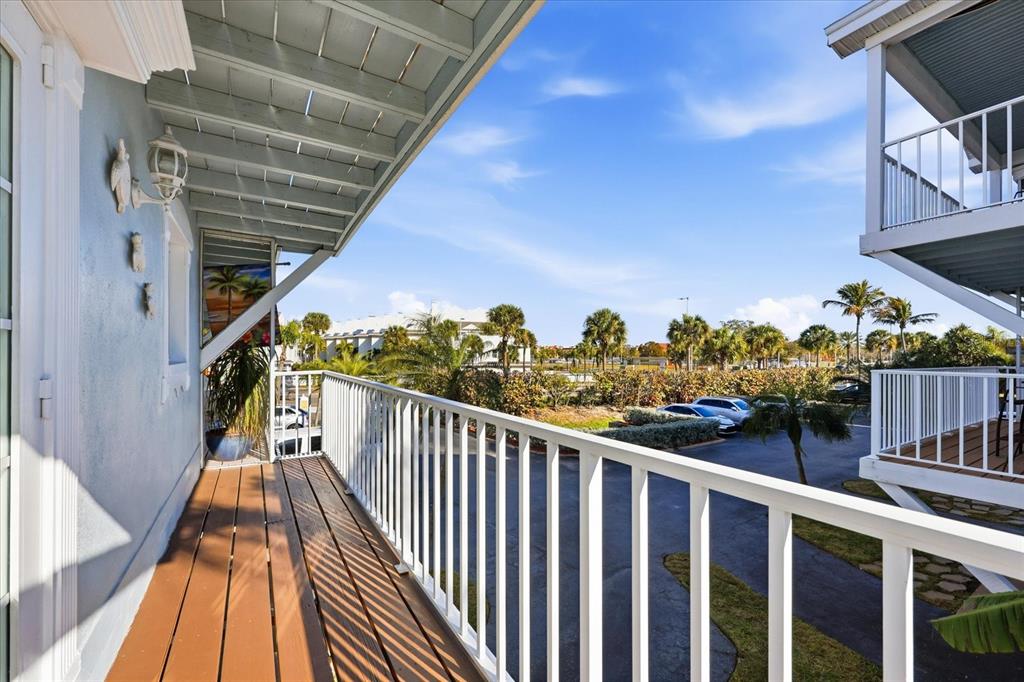 9170 Blind Pass Road St. Pete Beach, FL 33706 - Photo 18 of 58 a view of balcony with wooden floor